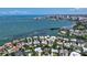 Waterfront home featuring lush landscaping, boat access, with views of the bay, neighborhood, city, and bridge at 1387 Harbor Dr, Sarasota, FL 34239