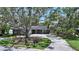 Inviting single-story home with a spacious driveway and mature trees at 1387 Harbor Dr, Sarasota, FL 34239