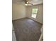 Cozy bedroom featuring neutral carpet, a ceiling fan, and a window overlooking the outdoors at 1422 Jakway Rd, North Port, FL 34288