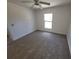 Bright bedroom with neutral carpet, ceiling fan, and a window at 1422 Jakway Rd, North Port, FL 34288