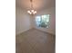 Bright dining room featuring tile floors, decorative chandelier, and window offering natural light at 1422 Jakway Rd, North Port, FL 34288