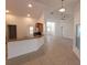 Open-concept kitchen with breakfast bar, white cabinets, and views to living and entry area at 1422 Jakway Rd, North Port, FL 34288