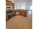 Kitchen area featuring stainless steel appliances, light colored cabinets and tile flooring at 1422 Jakway Rd, North Port, FL 34288