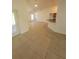 Open living room showcasing tile flooring, bright light and view to kitchen and other rooms at 1422 Jakway Rd, North Port, FL 34288