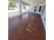 Covered patio offers an outdoor living space, with peeling paint on the floor at 1422 Jakway Rd, North Port, FL 34288