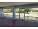 Screened in back patio with outdoor seating area overlooking the backyard at 1422 Jakway Rd, North Port, FL 34288