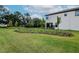 Exterior view of house and large green backyard with landscaping at 14787 Gallop Run Dr, Lithia, FL 33547