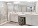 Stylish bathroom with dual vanity, glass shower, and decorative stool for added luxury at 14787 Gallop Run Dr, Lithia, FL 33547
