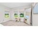 Bright, airy bedroom with plush carpeting, large windows, a bench, and a stylish mirror at 14787 Gallop Run Dr, Lithia, FL 33547