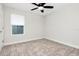 Empty bedroom with soft carpeting, neutral walls, and natural light from the window at 14787 Gallop Run Dr, Lithia, FL 33547