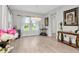 Bright dining room boasts modern light fixture, neutral walls, and wood-look floors, perfect for entertaining guests at 14787 Gallop Run Dr, Lithia, FL 33547