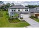 Charming two-story home features stone accents, a two-car garage, and a beautifully landscaped front yard at 14787 Gallop Run Dr, Lithia, FL 33547