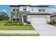 Charming two-story home features stone accents, a two-car garage, and a beautifully landscaped front yard at 14787 Gallop Run Dr, Lithia, FL 33547
