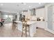 Bright, open kitchen with a large center island, pendant lighting, and white cabinets at 14787 Gallop Run Dr, Lithia, FL 33547