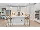 Bright, open kitchen with a large center island, pendant lighting, and white cabinets at 14787 Gallop Run Dr, Lithia, FL 33547