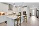 Bright, open kitchen with a large center island, pendant lighting, and white cabinets at 14787 Gallop Run Dr, Lithia, FL 33547