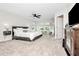 Spacious main bedroom with a modern bed frame, plush carpet, and great natural lighting at 14787 Gallop Run Dr, Lithia, FL 33547