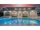 This modern home's backyard has a pool, patio, balcony, and beautiful evening sky at 1607 Flower Dr, Sarasota, FL 34239