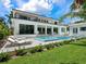 Luxury home featuring a private pool, outdoor seating, and manicured lawn at 1607 Flower Dr, Sarasota, FL 34239