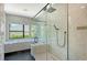 Beautiful bathroom with a soaking tub, walk-in shower, black hardware, marble tile and modern finishes at 1607 Flower Dr, Sarasota, FL 34239