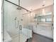 Sleek bathroom with a glass shower, marble tile, vanity with double sinks and modern lighting at 1607 Flower Dr, Sarasota, FL 34239