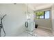 Modern bathroom featuring frameless glass shower and gray vanity at 1607 Flower Dr, Sarasota, FL 34239