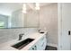 Elegant bathroom featuring marble-look walls, sleek fixtures, and dual sinks in a bright, modern setting at 1607 Flower Dr, Sarasota, FL 34239
