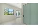 Bright bedroom features tile flooring, a large window and a balcony access at 1607 Flower Dr, Sarasota, FL 34239