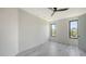 Bedroom with gray floors, two windows, and neutral decor at 1607 Flower Dr, Sarasota, FL 34239