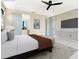 Modern bedroom with neutral tones, ceiling fan, and ensuite bathroom entrance at 1607 Flower Dr, Sarasota, FL 34239