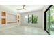 Bright, airy bedroom with neutral walls, tile floors, ceiling fan, and view of exterior balcony at 1607 Flower Dr, Sarasota, FL 34239