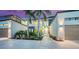 Modern home with palm trees, manicured landscaping, and a spacious multi-car driveway at 1607 Flower Dr, Sarasota, FL 34239