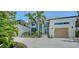 Stunning contemporary home featuring a clean white facade, palm trees, and lush landscaping at 1607 Flower Dr, Sarasota, FL 34239