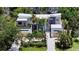 Aerial view of modern home with lush tropical landscaping and a spacious front yard and two car garage at 1607 Flower Dr, Sarasota, FL 34239