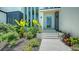 Close up view of modern front entrance with lush tropical foliage, and stone walkway at 1607 Flower Dr, Sarasota, FL 34239