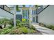Modern home exterior featuring vibrant landscaping, palm trees, and contemporary architectural design at 1607 Flower Dr, Sarasota, FL 34239