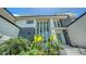Modern home exterior featuring vibrant landscaping, palm trees, and contemporary architectural design at 1607 Flower Dr, Sarasota, FL 34239