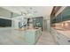 Gourmet kitchen offering an island with a sink, modern appliances, and an open layout great for entertaining at 1607 Flower Dr, Sarasota, FL 34239