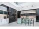 Modern kitchen with stainless steel appliances, beautiful cabinetry, and sleek breakfast bar at 1607 Flower Dr, Sarasota, FL 34239