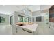 Bright, open kitchen with an island, modern cabinets, stainless sink, and views into the living room and outdoor balcony at 1607 Flower Dr, Sarasota, FL 34239