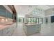 Bright, open kitchen with an island, modern cabinets, stainless sink, and views into the living room and outdoor balcony at 1607 Flower Dr, Sarasota, FL 34239