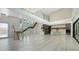 Spacious open-concept living area featuring modern staircase, floor to ceiling windows, and sleek kitchen design at 1607 Flower Dr, Sarasota, FL 34239
