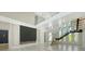 Bright modern living area with a fireplace, floating staircase, and large windows offering serene views at 1607 Flower Dr, Sarasota, FL 34239
