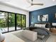 Stylish main bedroom features modern decor, dark accent wall, and private outdoor access at 1607 Flower Dr, Sarasota, FL 34239