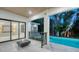 Inviting outdoor living area with a cozy fire pit and views of the sparkling swimming pool at 1607 Flower Dr, Sarasota, FL 34239