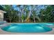 An alluring, newly built, backyard pool surrounded by beautiful, lush tropical landscaping at 1607 Flower Dr, Sarasota, FL 34239