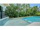 A modern pool and spa surrounded by lush tropical landscaping, perfect for relaxation and entertaining at 1607 Flower Dr, Sarasota, FL 34239
