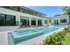 Beautiful backyard pool and spa with covered patio and lush landscaping, perfect for outdoor relaxation at 1607 Flower Dr, Sarasota, FL 34239