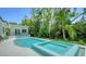 Relax in this modern pool and spa surrounded by lush tropical landscaping, perfect for a private retreat at 1607 Flower Dr, Sarasota, FL 34239