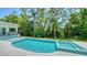 A modern pool and spa surrounded by lush tropical landscaping create a private backyard retreat at 1607 Flower Dr, Sarasota, FL 34239